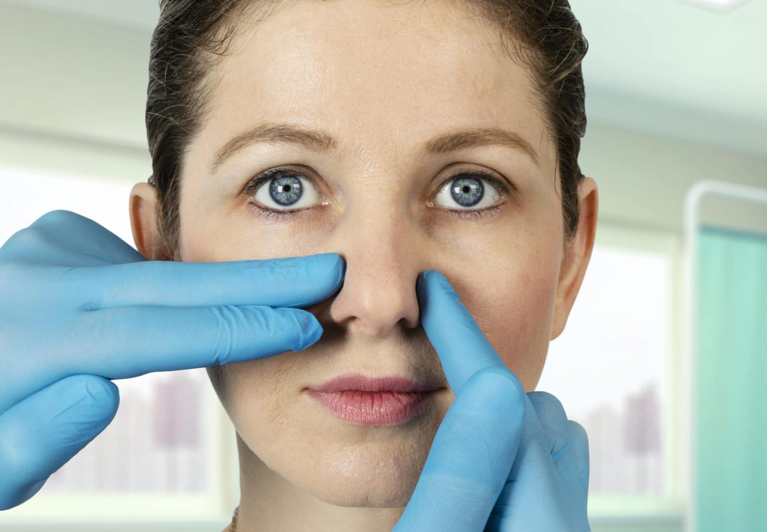 Doctor diagnosing a woman's nose for a septum deviation