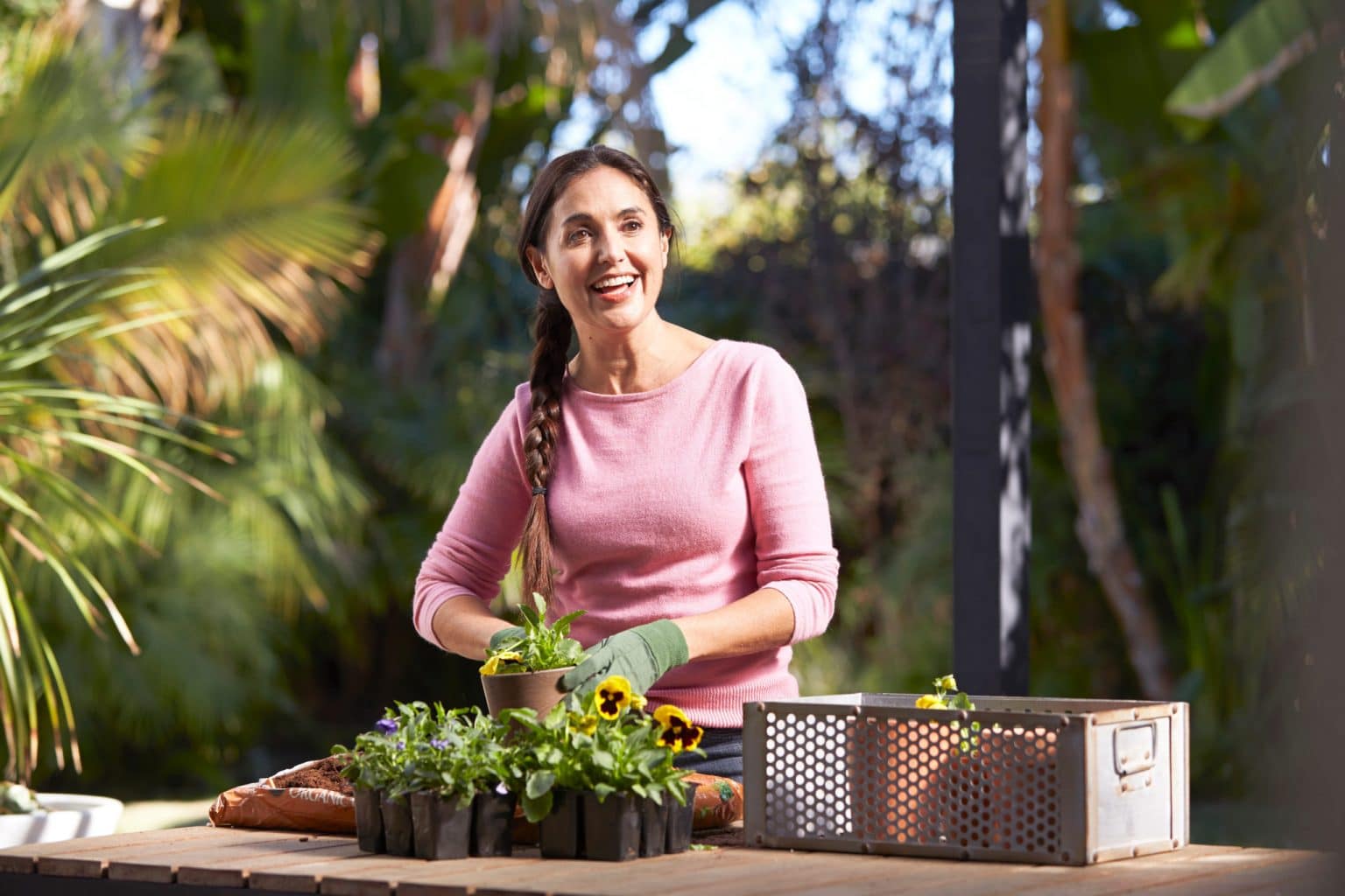 Woman potting plants and breathing better after vivaer treatment for nasal obstruction.